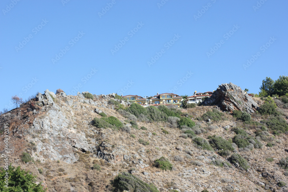 Alanya, TURKEY - August 10, 2013: Travel to Turkey. Helene Hills. Mountains in the background in the distance. Rocks, wildlife of Turkey. Forest and clear blue sky.