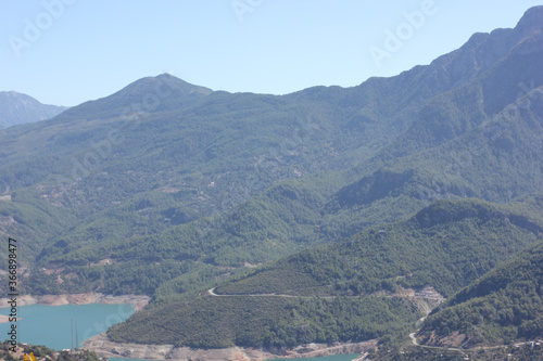 Alanya, TURKEY - August 10, 2013: Travel to Turkey. Helene Hills. Mountains in the background in the distance. Rocks, wildlife of Turkey. Forest and clear blue sky. © andreswestrum