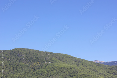 Alanya, TURKEY - August 10, 2013: Travel to Turkey. Helene Hills. Mountains in the background in the distance. Rocks, wildlife of Turkey. Forest and clear blue sky.