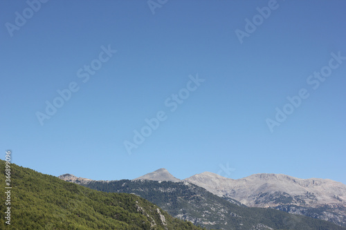 Alanya, TURKEY - August 10, 2013: Travel to Turkey. Helene Hills. Mountains in the background in the distance. Rocks, wildlife of Turkey. Forest and clear blue sky.