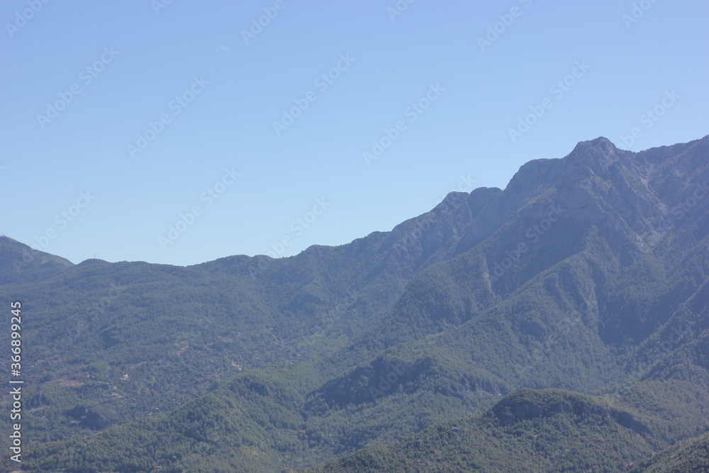 Alanya, TURKEY - August 10, 2013: Travel to Turkey. Helene Hills. Mountains in the background in the distance. Rocks, wildlife of Turkey. Forest and clear blue sky. Alanya, TURKEY - August 10, 2013: Travel to Turkey. Helene Hills. Mountains in the background in the distance. Rocks, wildlife of Turkey. Forest and clear blue sky.