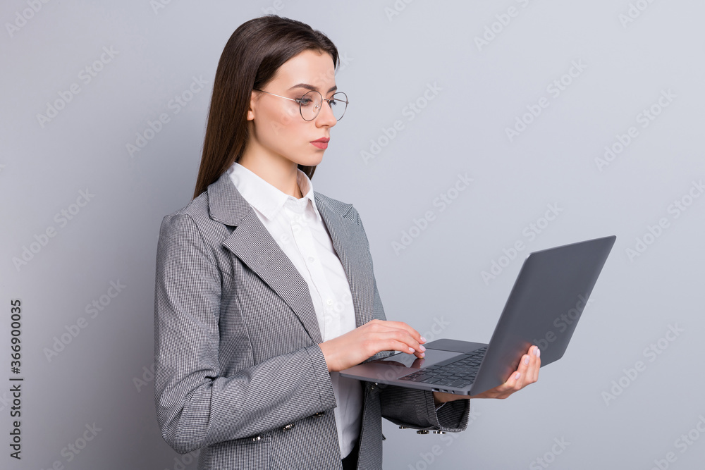 Photo of attractive business lady self-confident manager worker hold notebook hands browsing look seriously screen wear specs shirt checkered blazer isolated grey color background Photo of attractive business lady self-confident manager worker hold notebook hands browsing look seriously screen wear specs shirt checkered blazer isolated grey color background