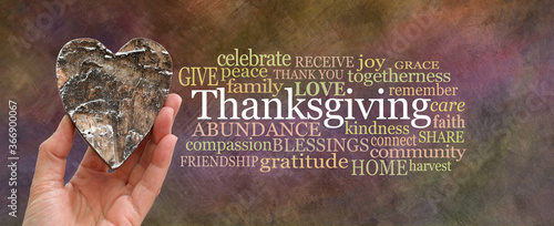 Tableau sur toile Put some love into Thanksgiving Word Cloud concept - hand holding a rustic brown