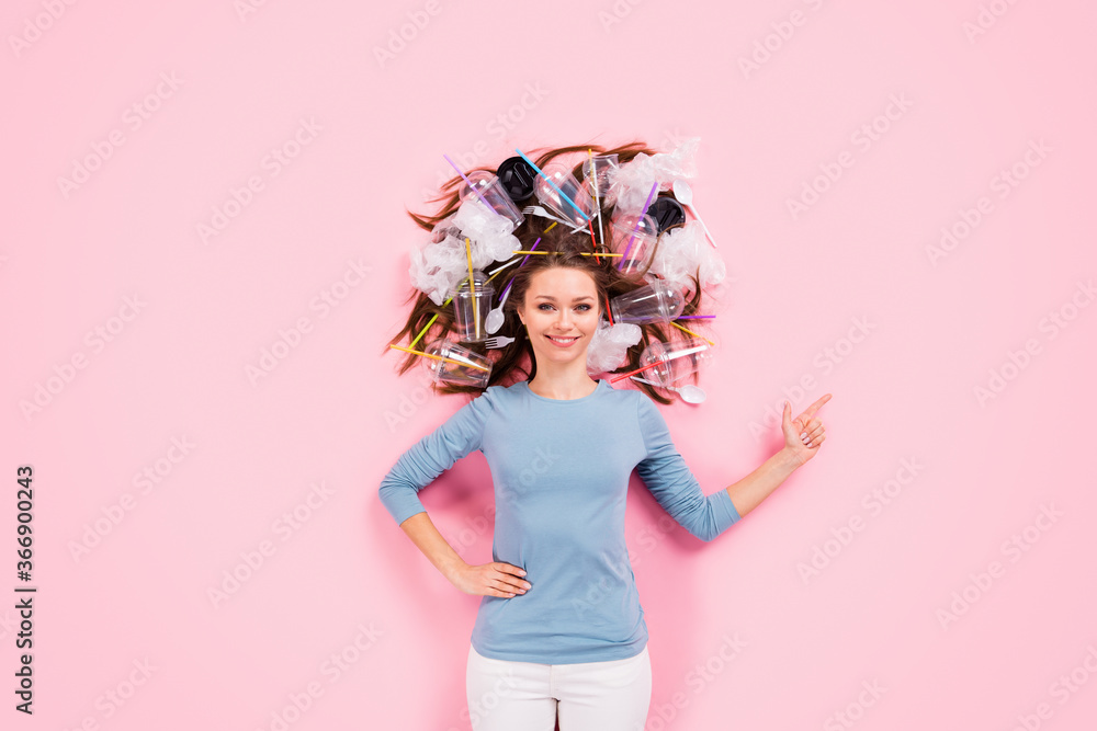 Top above high angle view photo positive girl eco promoter point finger copyspace present eco friendly ads wear sweater flat lay hair plastic bags cup trash isolated pastel color background
