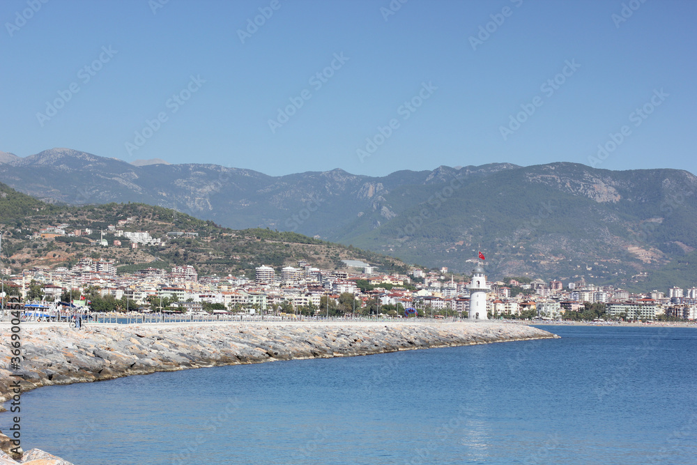 Obraz premium Alanya, TURKEY - August 10, 2013: Travel to Turkey. Berth with boats, boats and yachts. Clear blue sky. The waves of the Mediterranean Sea. Water surface.