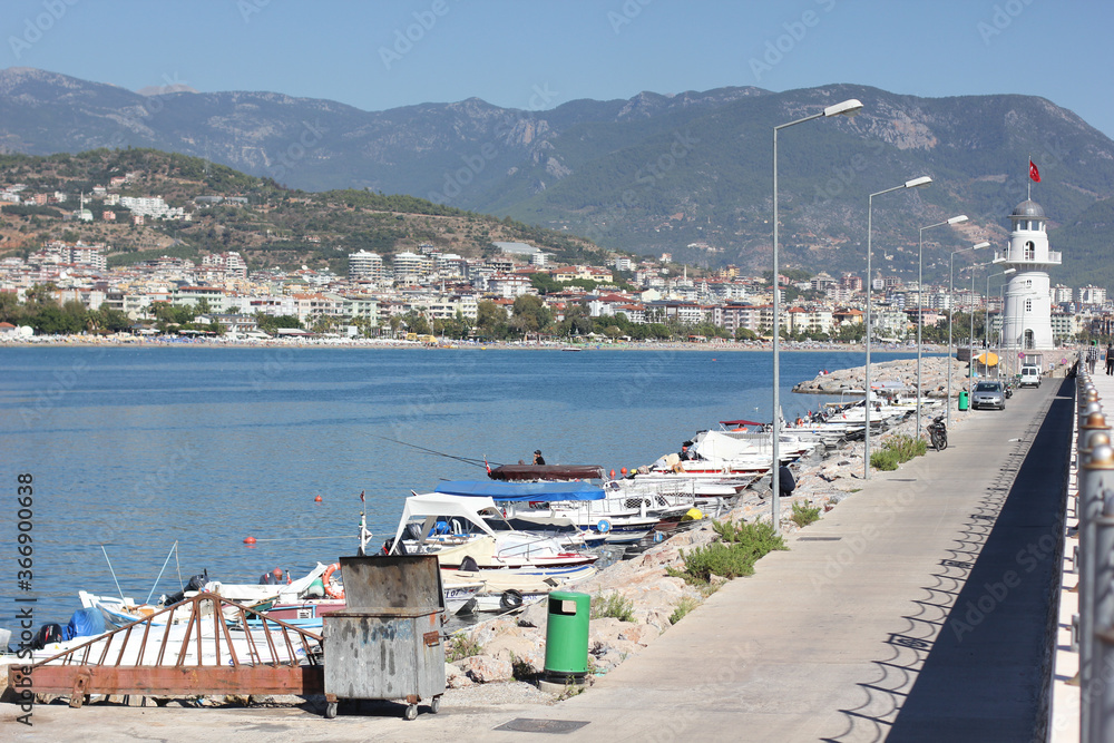 Alanya, TURKEY - August 10, 2013: Travel to Turkey. Berth with boats, boats and yachts. Clear blue sky. The waves of the Mediterranean Sea. Water surface.