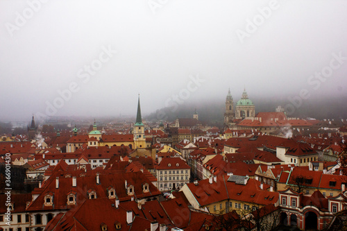 Red roofs of Prague on a foggy day. Prague city view from above. Panorama of Prague. Prague on a foggy day. Fog over the city.