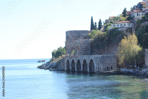 Alanya, TURKEY - August 10, 2013: Travel to Turkey. Greenery. Flowers. Green hills. The mountains. Rocks, wildlife of Turkey. Forest and clear blue sky. The waves of the Mediterranean Sea. Water surfa photo