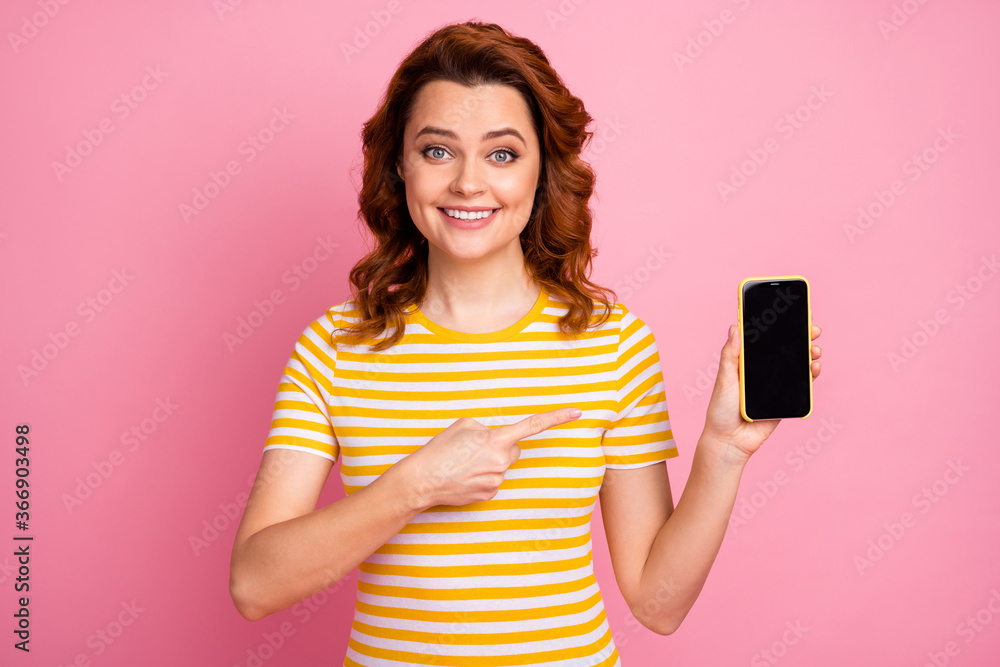 Close-up portrait of her she nice attractive lovely pretty charming confident cheerful cheery wavy-haired girl holding in hand showing cell ad advert isolated over pink pastel color background Close-up portrait of her she nice attractive lovely pretty charming confident cheerful cheery wavy-haired girl holding in hand showing cell ad advert isolated over pink pastel color background
