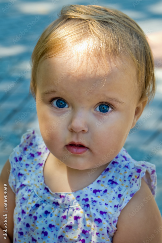 A cute little girl looks into the frame. Soft focus. A cute little girl looks into the frame. Soft focus.