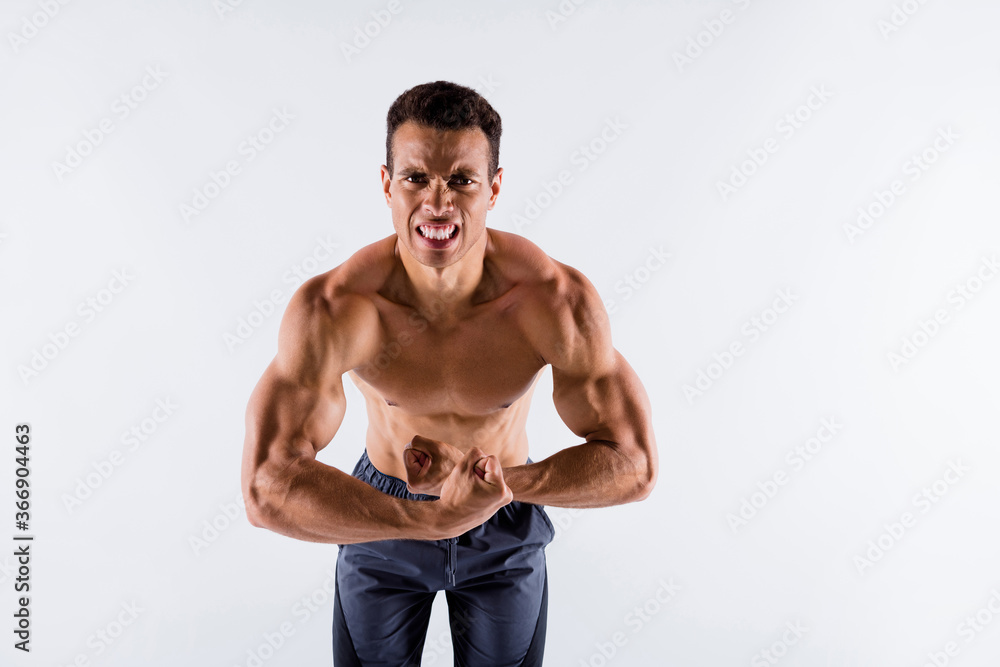 Portrait of his he nice attractive powerful strong concentrated dedicated devoted tanned guy making effort showing muscles isolated over light white pastel color background Portrait of his he nice attractive powerful strong concentrated dedicated devoted tanned guy making effort showing muscles isolated over light white pastel color background