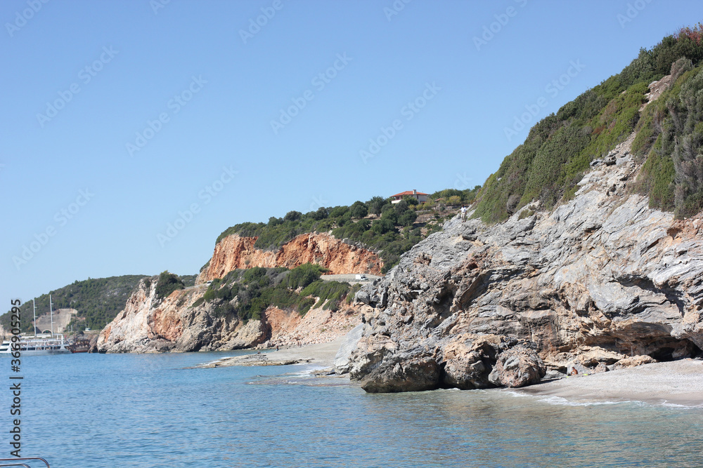 Alanya, TURKEY - August 10, 2013: Travel to Turkey. The waves of the Mediterranean Sea. Water surface. Mountains and hills on the coast of Turkey. Green hills. Port. Alanya, TURKEY - August 10, 2013: Travel to Turkey. The waves of the Mediterranean Sea. Water surface. Mountains and hills on the coast of Turkey. Green hills. Port.