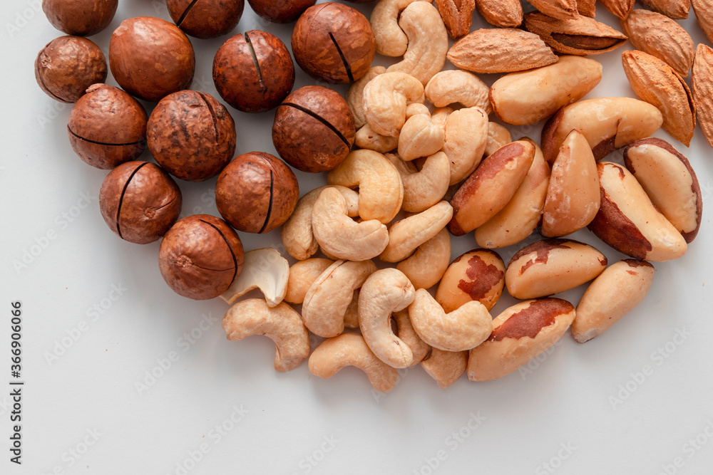 Obraz premium Background of mix nuts pecan, macadamia, walnut, almonds, hazelnuts Top view, flat lay