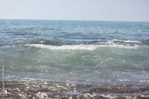 Fototapeta Naklejka Na Ścianę i Meble -  Alanya, TURKEY - August 10, 2013: Travel to Turkey. Beaches on the sea. Waves on the Mediterranean coast.