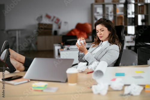Beautiful young businesswoman working on projects. Businesswoman in suit working in the office.	