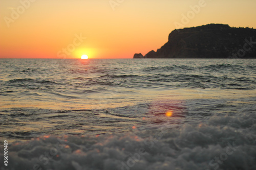 Alanya, TURKEY - August 10, 2013: Travel to Turkey. Sunset at the sea. The sun is leaving the horizon.