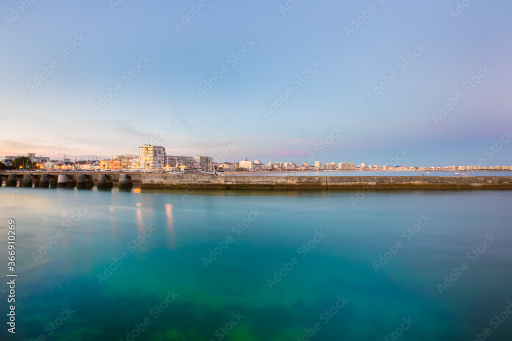 Entrance of Les Sables D'Olonne harbour taken from La Chaume, with it piers and lighthouse at sunset, Vendee, France