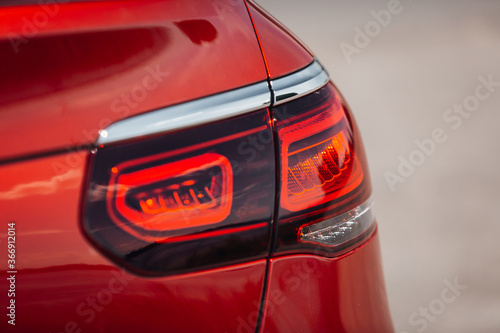 Modern car rear taillight lamp in the front of sky