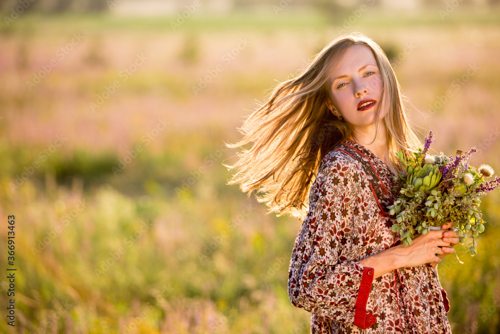 Beautiful woman with wildflower over natural background Beautiful woman with wildflower over natural background