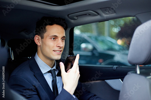 Business executive talking on mobile phone while traveling in car © JoseIMartin