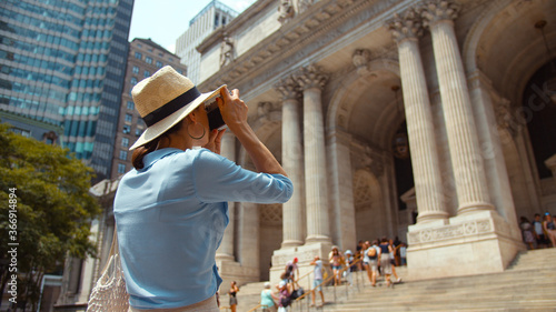 Young tourist taking a photo in the city