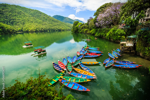 Colorful boats on the boarder of the Phewa Lake at Pokhara, Nepal.
