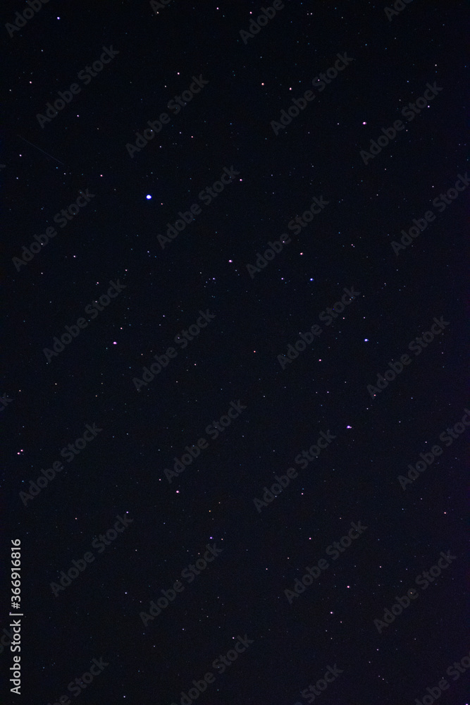 Naklejka premium Space background on the desktop, screensaver. Night starry sky of the Northern hemisphere. Various cosmic bodies and constellations. The stars are like small bright lights.