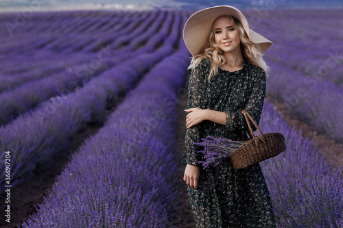 fashion portrait of a young pretty woman in lavender field