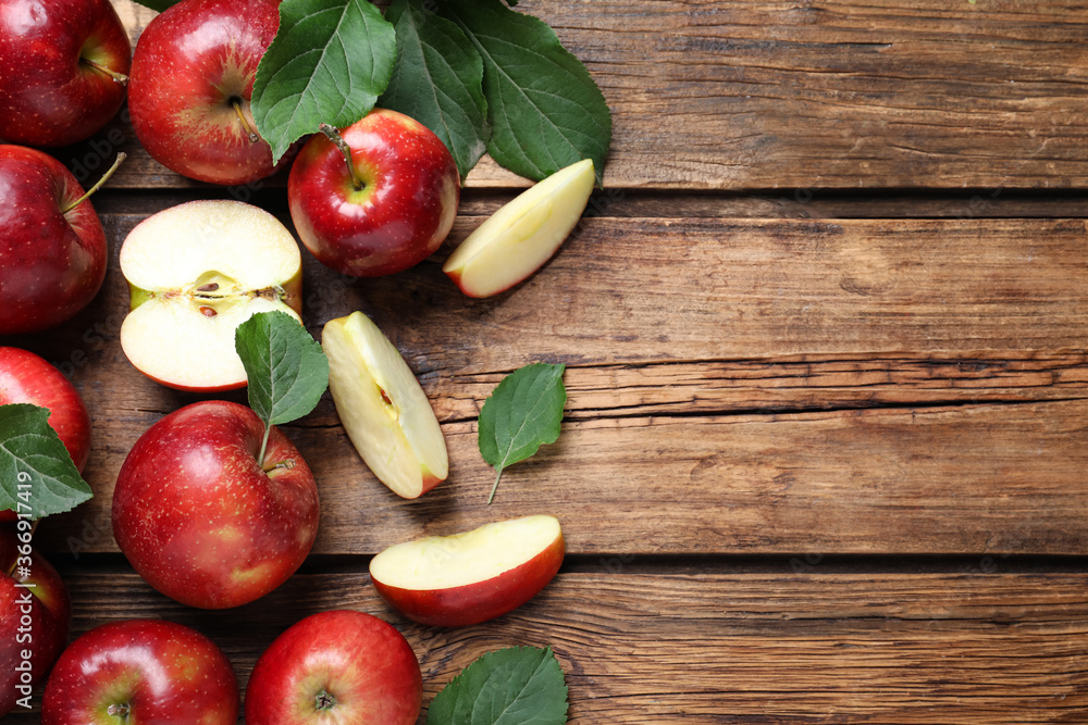 Ripe juicy red apples on wooden table, flat lay. Space for text Ripe juicy red apples on wooden table, flat lay. Space for text