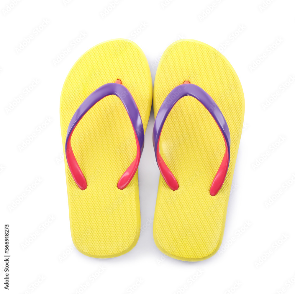 Pair of stylish yellow flip flops isolated on white, top view. Beach object Pair of stylish yellow flip flops isolated on white, top view. Beach object