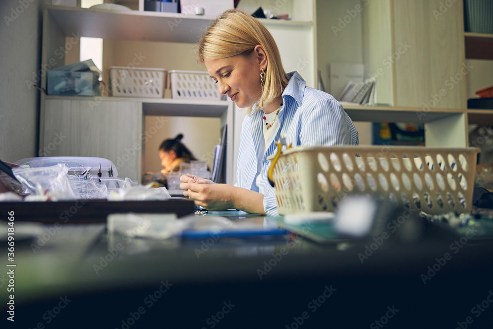 Handcraft process of jewel employee in workroom