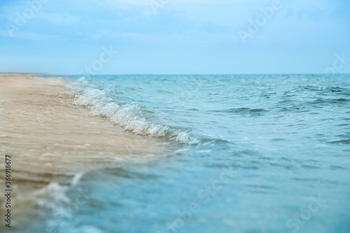 Beautiful view of sea tide on sandy beach. Summer vacation