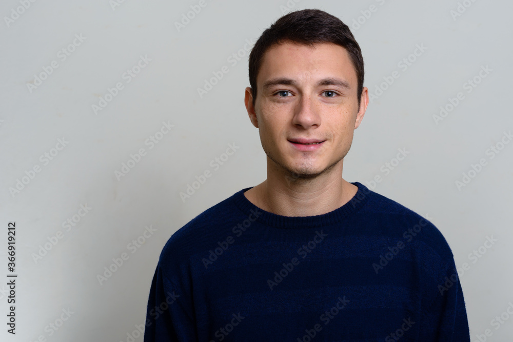 Studio shot of handsome man wearing sweater Studio shot of handsome man wearing sweater