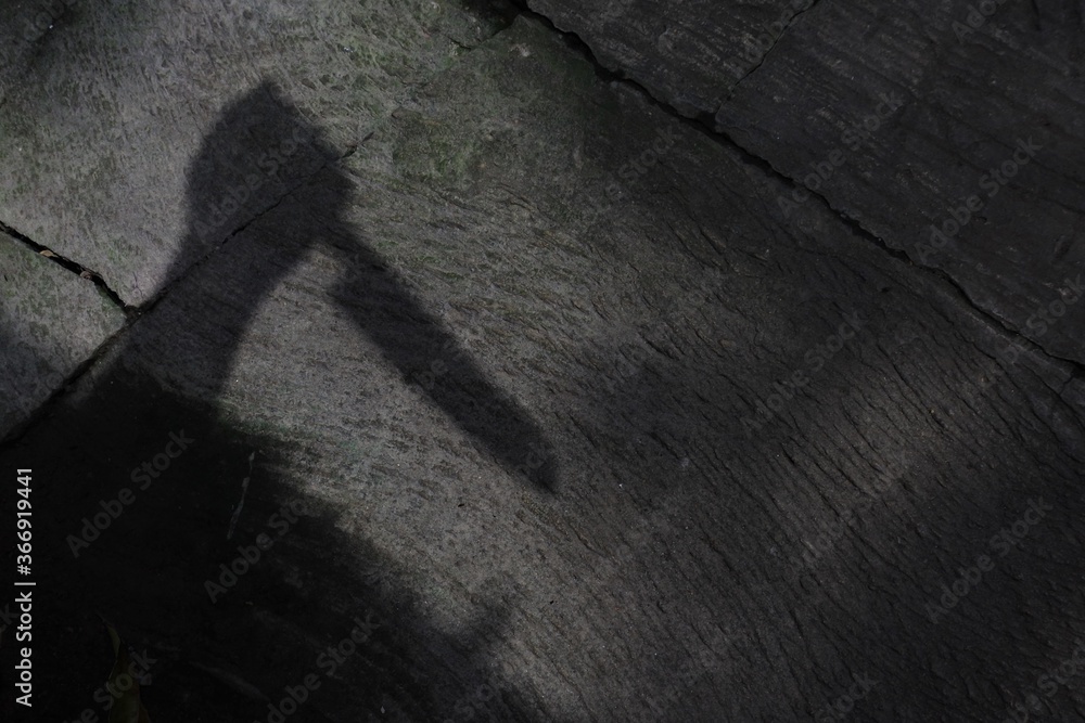 High angle shot of a shadow of human hand holding a knife- murder concept
