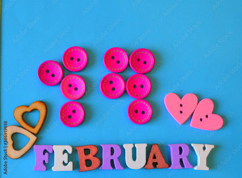 Fototapeta premium 14 February inscription made of wooden buttons against blue background, Saint Valentine's greeting card. DIY 