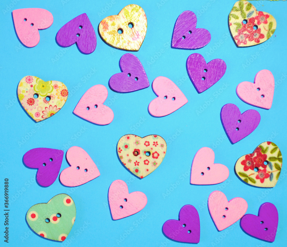Romantic background with wooden multicoloured buttons in form of hearts against light-blue background. Concept for Saint Valentine's or romantic card. Romantic wallpaper, love Romantic background with wooden multicoloured buttons in form of hearts against light-blue background. Concept for Saint Valentine's or romantic card. Romantic wallpaper, love