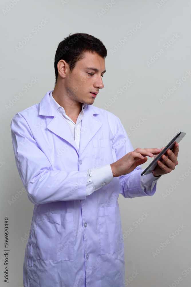 Portrait of handsome man doctor against white background Portrait of handsome man doctor against white background