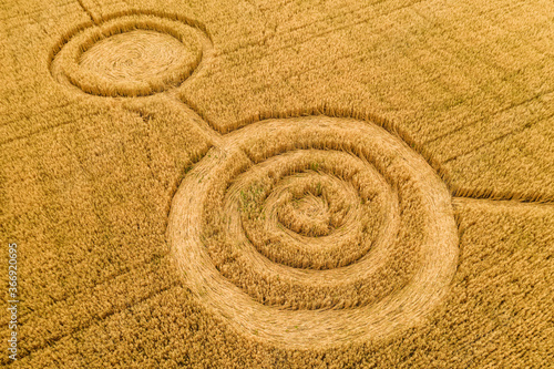 Fotografie Fake UFO circles on grain crop yellow field, aerial view from drone