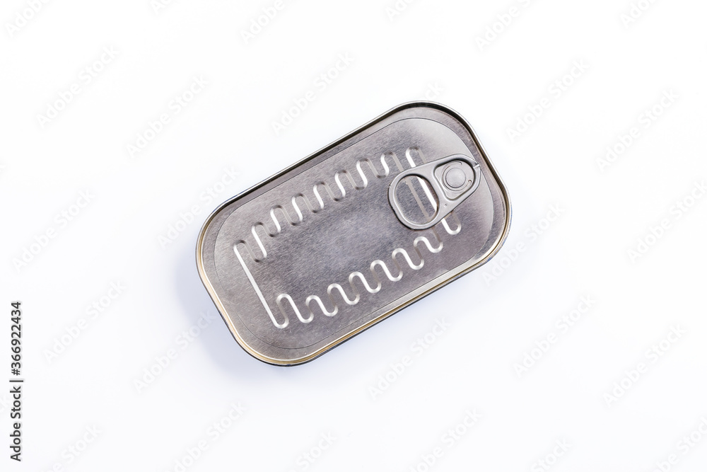 Canned fish in sealed oval tin can with easy openable lid on a white background - top view
Canned fish in sealed oval tin can with easy openable lid on a white background - top view