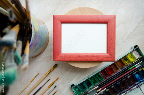 Frame mock up for your art, photo, sketch, illustration with paint brushes on light background. 