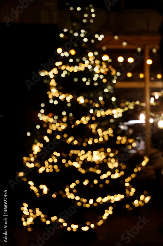 Defocused lights on Christmas tree. Christmas atmosphere. 