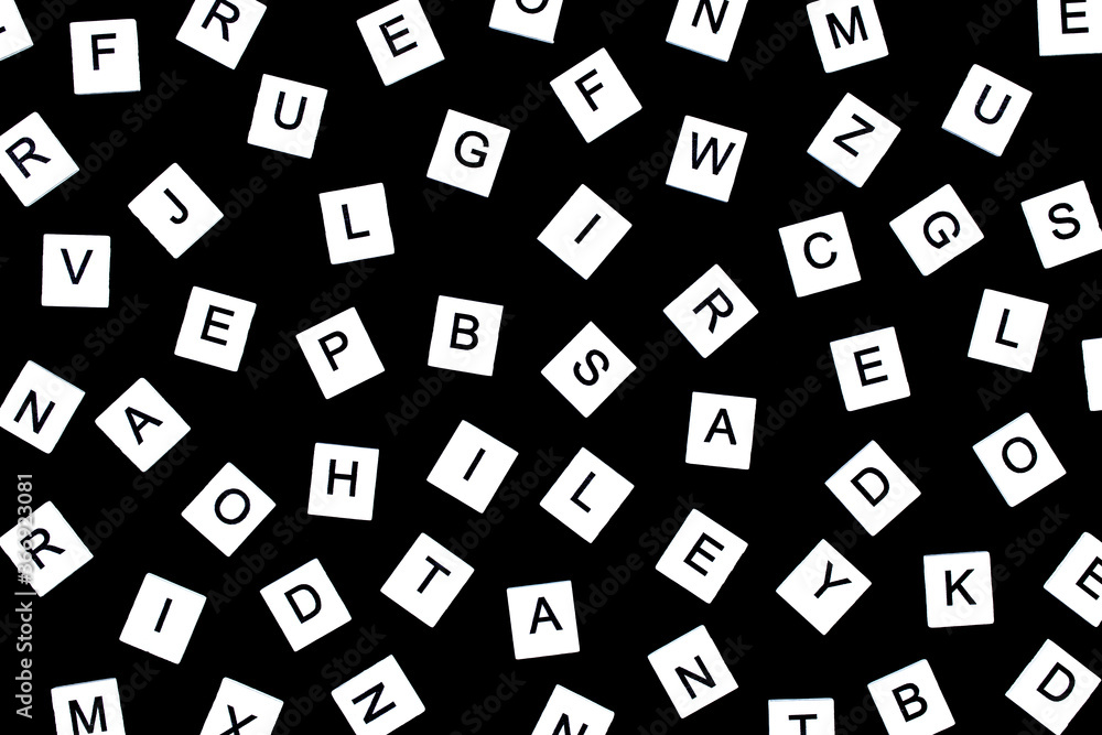 Alphabet background in black and white. Letters of English alphabet on black background. black and white pattern of randomly placed letters. Flat Lay, Copy space, top view Alphabet background in black and white. Letters of English alphabet on black background. black and white pattern of randomly placed letters. Flat Lay, Copy space, top view