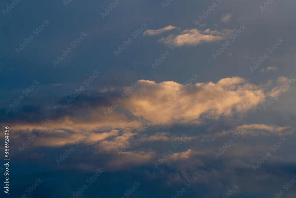 Dark blue sky, cumulus clouds. Sunset. Dark blue sky, cumulus clouds. Sunset.