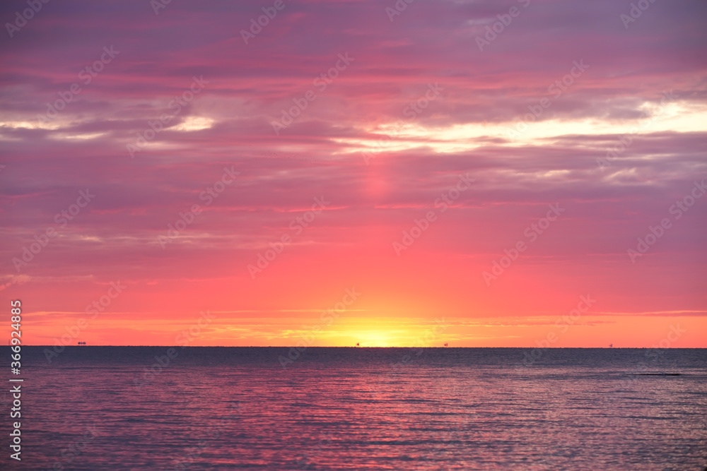 Colorful red sunset sunrise at sea. Water and sky. Minimalism in nature. Dark photo at dusk. Sea landscape. Colorful red sunset sunrise at sea. Water and sky. Minimalism in nature. Dark photo at dusk. Sea landscape.