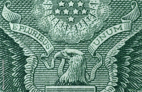 Picture of part of Great Seal of the United States with writing E Pluribus Unum, Out of many one, printed on One USA dollar banknote photo