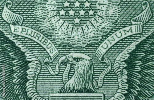 Picture of part of Great Seal of the United States with writing E Pluribus Unum, Out of many one, printed on One USA dollar banknote