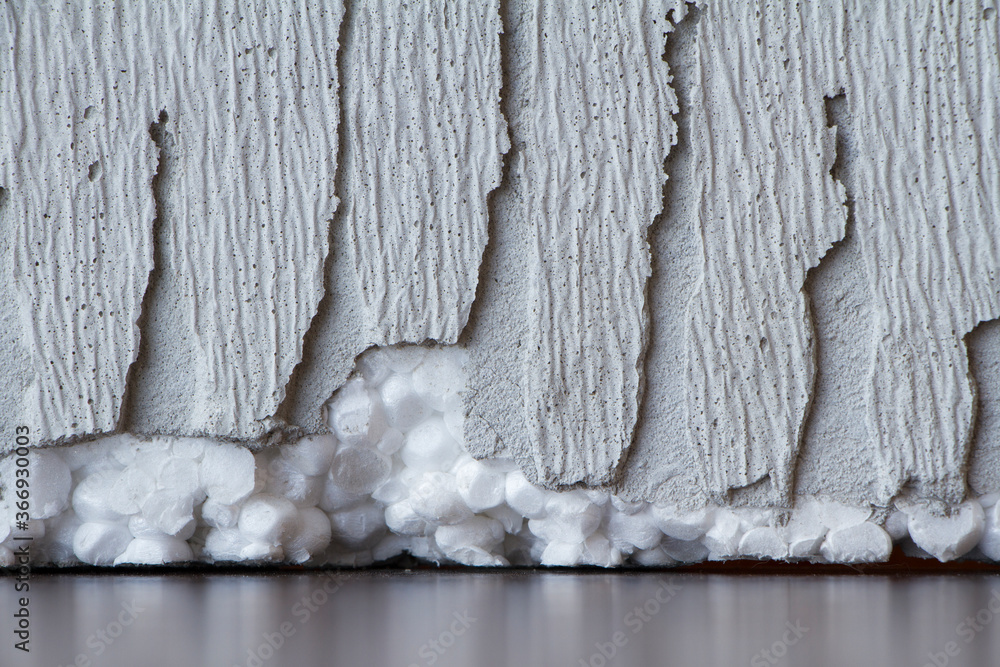 Adhesive for fixing foam. Polyfoam for facade insulation. Closeup glue on white rigid
