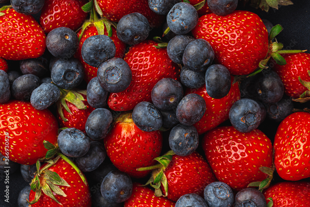 Close up photo of blueberries and strawberries Close up photo of blueberries and strawberries