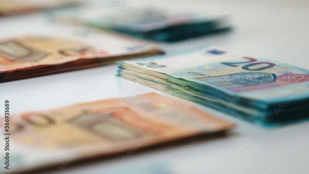 Close-up of euro banknotes, stacks of paper currency lying on white background. Financial transactions and stock market, great earnings and savings. Successful business, high income and money for Close-up of euro banknotes, stacks of paper currency lying on white background. Financial transactions and stock market, great earnings and savings. Successful business, high income and money for