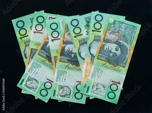 Australian currency 100 dollar notes on black background